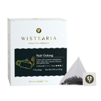 Wistearia Noir Oolong Tea sachets box beside a pyramid tea sachet and brand tag
